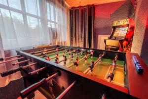a foosball table in a living room with at Weingut Muehlenschenke - Game-Room, Vineyard, Sauna and more in Sankt Goarshausen