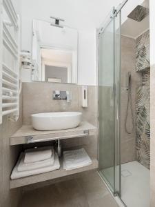 a bathroom with a sink and a glass shower at EMMEhouse in Sant'Agnello +31 photos