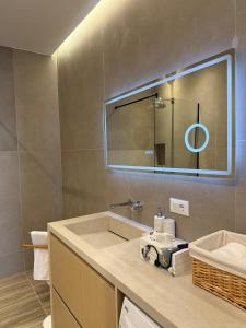 a bathroom with a sink and a mirror at Turquoise Pool Side Thymus Resort in Himare