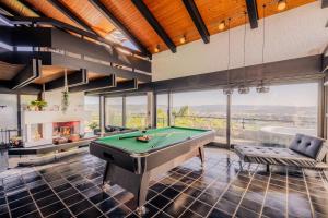 a billiard room with a pool table and a fireplace at Villa Panoramica Pool & Sauna in Weitersburg