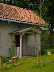 a small white house with a red roof at Po Prostu Dobro in Mrągowo