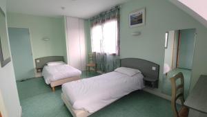 a bedroom with two beds and a window at Ternelia Village vacances Sainte Montaine in Sainte-Montaine