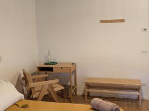 a room with a table and two chairs and a desk at Casa di Campagna in Fregene +3 photos