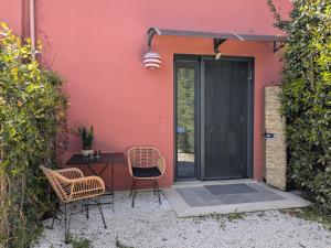 a patio with a table and chairs next to a building at Casa di Campagna in Fregene