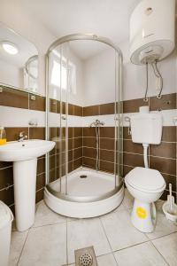 a bathroom with a shower and a toilet and a sink at Apartments Dragičević 6 with Garage in Budva