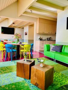 a living room with a green couch and a table at De Veurdeale in Havelte +81 photos