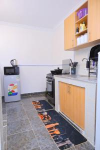 a kitchen with a stove and a counter top at 1 bedroom in Kamakis in Ruiru