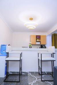 a kitchen with two chairs and a counter top at 1 bedroom in Kamakis in Ruiru