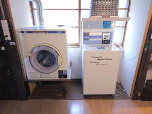 a washing machine sitting next to a washer at Former inn "Oyado Wada-juku" - Vacation STAY 36970v in Nagawa