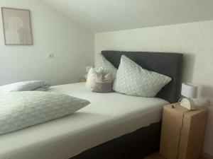 a bed with white sheets and pillows in a bedroom at Bauernhof Haus Sturm in Jerzens