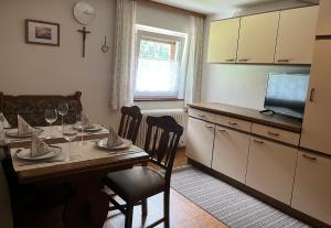 a kitchen with a table with wine glasses on it at Bauernhof Haus Sturm in Jerzens