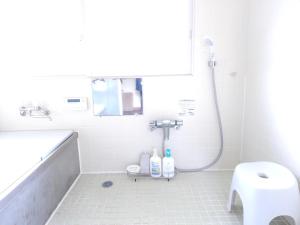 a white bathroom with a shower and a sink at Former inn "Oyado Wada-juku" - Vacation STAY 03818v in Nagawa +6 photos