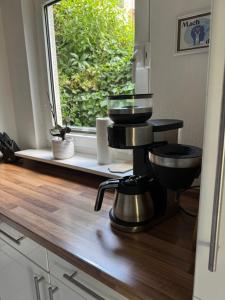 a kitchen with a juicer on a counter with a window at Ferienwohnung -Schwalbe in Attendorn