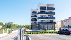a building with a car parked in front of it at Hotel Lejla in Ulcinj