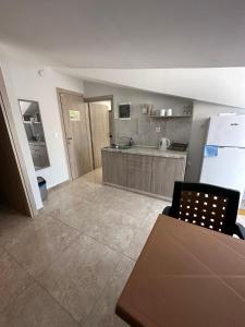 a large kitchen with a table and a refrigerator at F&R Villa - Family Apartment No6 - 2 bedrooms in Perea