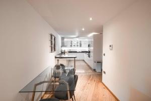 a dining room with a glass table in a room at 3 bed Ocean Spa Plaza Luxurious flat in Gibraltar