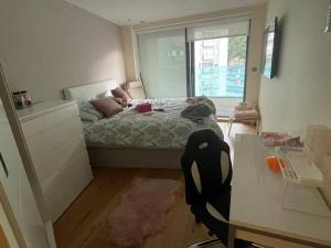 a small bedroom with a bed and a window at 3 bed Ocean Spa Plaza Luxurious flat in Gibraltar