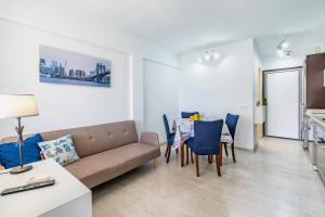 a living room with a couch and a table and chairs at Apartamento Los Angeles by Mallorca Infinity in Paguera