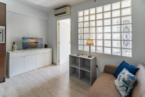 a living room with a couch and a television at Apartamento Los Angeles by Mallorca Infinity in Paguera