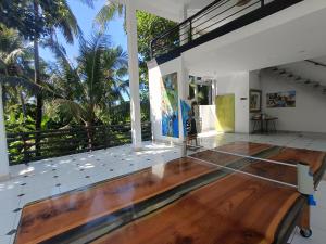 an empty room with a wooden floor and a balcony at Skylodge B&B - Bali Jungle Retreat with Fine Dining & Eco Pool in Bukti