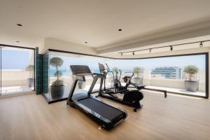 a gym with two treadmills and two exercise bikes at Hotel RH Arena - Todo Incluido in Gandía