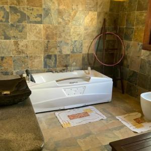 a bathroom with a white tub in a room at Villa Sahitia Marine in Mahajanga +10 photos