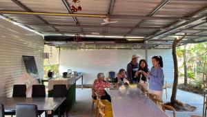 a group of people standing in a room with tables at อุ่นฟ้าอิงดาว Nordic 2 in Ban Kom