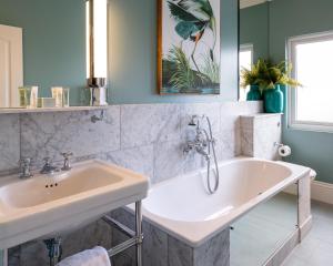 a bathroom with two sinks and a tub at Roslin Beach Hotel in Southend-on-Sea +37 photos