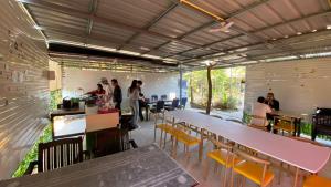 a group of people in a restaurant with tables and chairs at อุ่นฟ้าอิงดาว Nordic 2 in Ban Kom