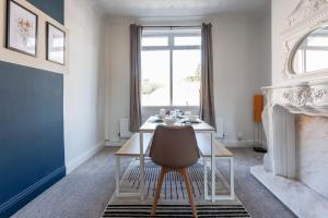 a dining room with a table and a fireplace at Spacious 2 bedroom with dining room in Stockton-on-Tees +39 photos