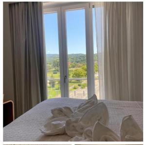 a bedroom with a bed with a large window at Home & B in Arezzo