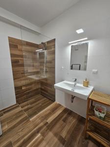 a bathroom with a white sink and a shower at Soblahov apartment in Soblahov