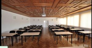 a classroom with tables and chairs in a room at Park Hotel Panorama in Tryavna