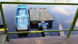 two boats sitting next to a dock in the water at Holiday Home Baracka in Bezdan