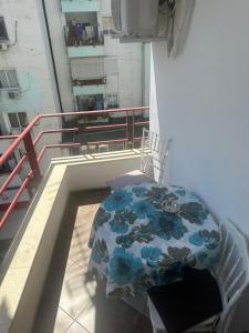 a table and chairs on the balcony of a building at Dora apartment in Tirana