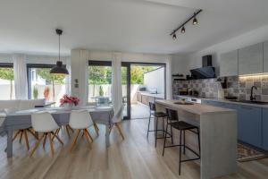 a kitchen and dining room with a table and chairs at Villa Ventana with terrace and BBQ in Savudrija