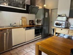 a kitchen with a stainless steel refrigerator and a sink at Landhaus am Deich in Cluvenhagen