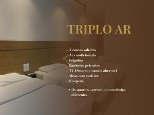 a hotel room with a bed and a sign on the wall at HLN Hotel - Expo - Anhembi in São Paulo