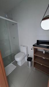 a bathroom with a toilet and a glass shower at Pousada Muller in Paraíso do Sul
