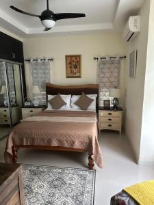 a bedroom with a bed and a ceiling fan at Villa Christine in Ocho Rios