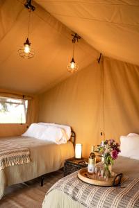 a bedroom with two beds in a tent at Painted Prairie - Prairie Hause in Currie