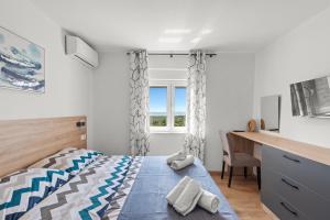 a bedroom with a bed and a desk and a window at Villa Marko by aneo travel in Ledenice +41 photos