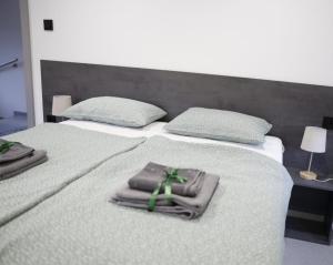 a bedroom with two beds with towels on them at Villa L&M in Bihać +19 photos
