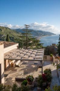 a patio with a view of the water at Villa Fiorita Boutique Hotel in Taormina