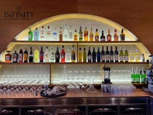 a bar filled with lots of bottles and glasses at Infinity Plaza Hotel in Gjakove