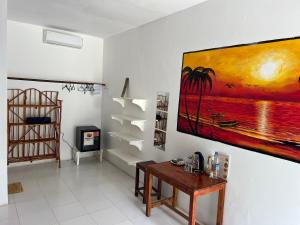 a living room with a large painting on the wall at Zanzi beach hotel in Nungwi