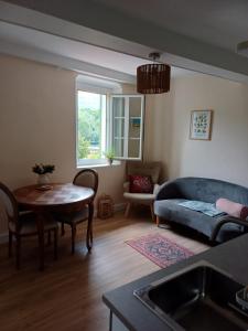 a living room with a couch and a table at Riverview in Sospel +29 photos