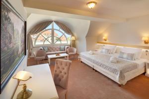 a bedroom with a large bed and a large window at Hotel Savoy Prague in Prague +126 photos