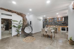 una sala da pranzo e una cucina con tavolo e sedie di Luxury Home la Cueva del Guanche ad Adeje