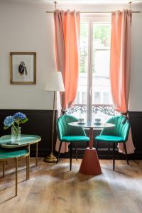 a room with two tables and chairs and a window at Maison 1887 in Paris